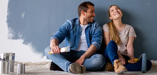 A couple using their heloc loan to paint their house.