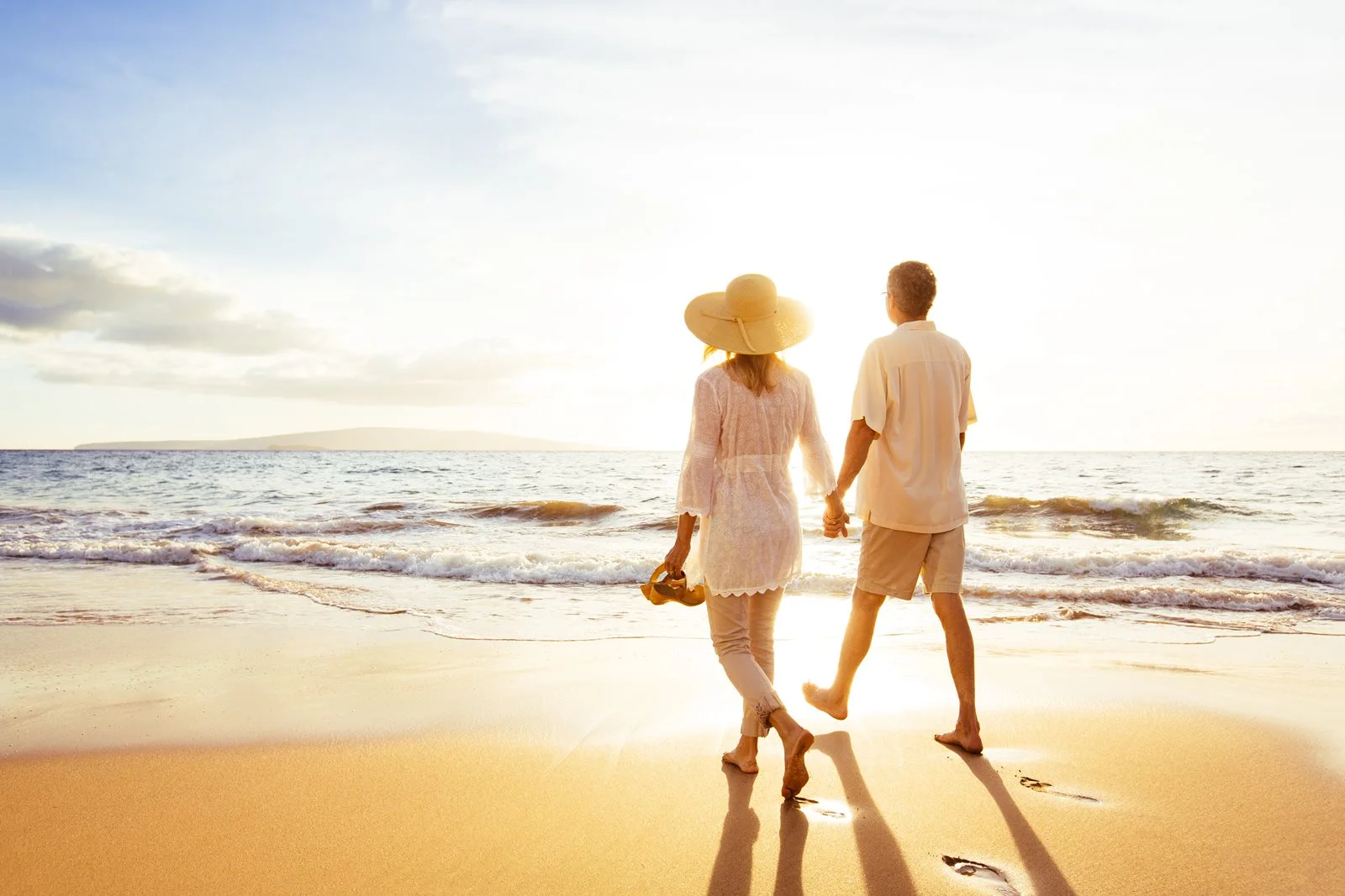 A couple walking on the beach.