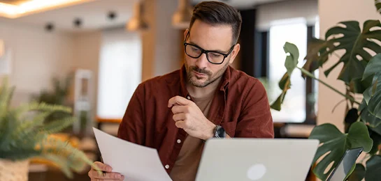 Man doing his banking at a desk. 