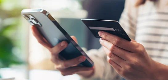 Women using Paducah Bank debit card to shop online.