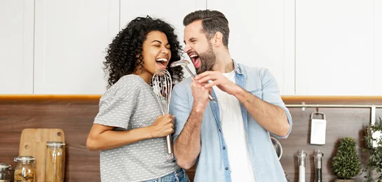 A couple singing in their new house.