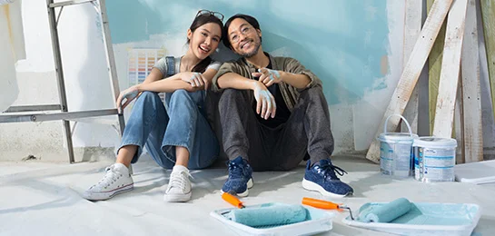A couple painting their new home. 