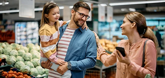 A family using their wow app at the grocery store.