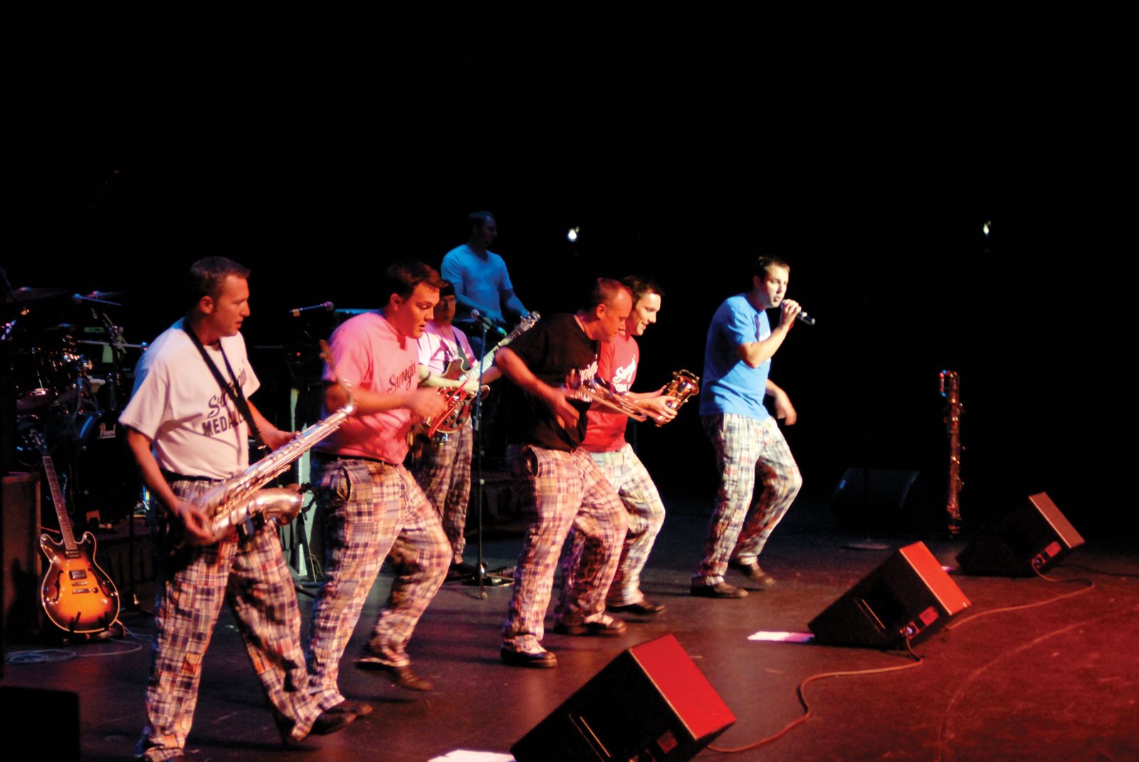 People playing instruments on stage at concert