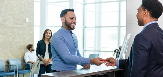 Bank teller waiting on a customer.