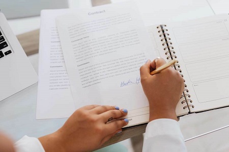 Writing Financial goals in the notebook.
