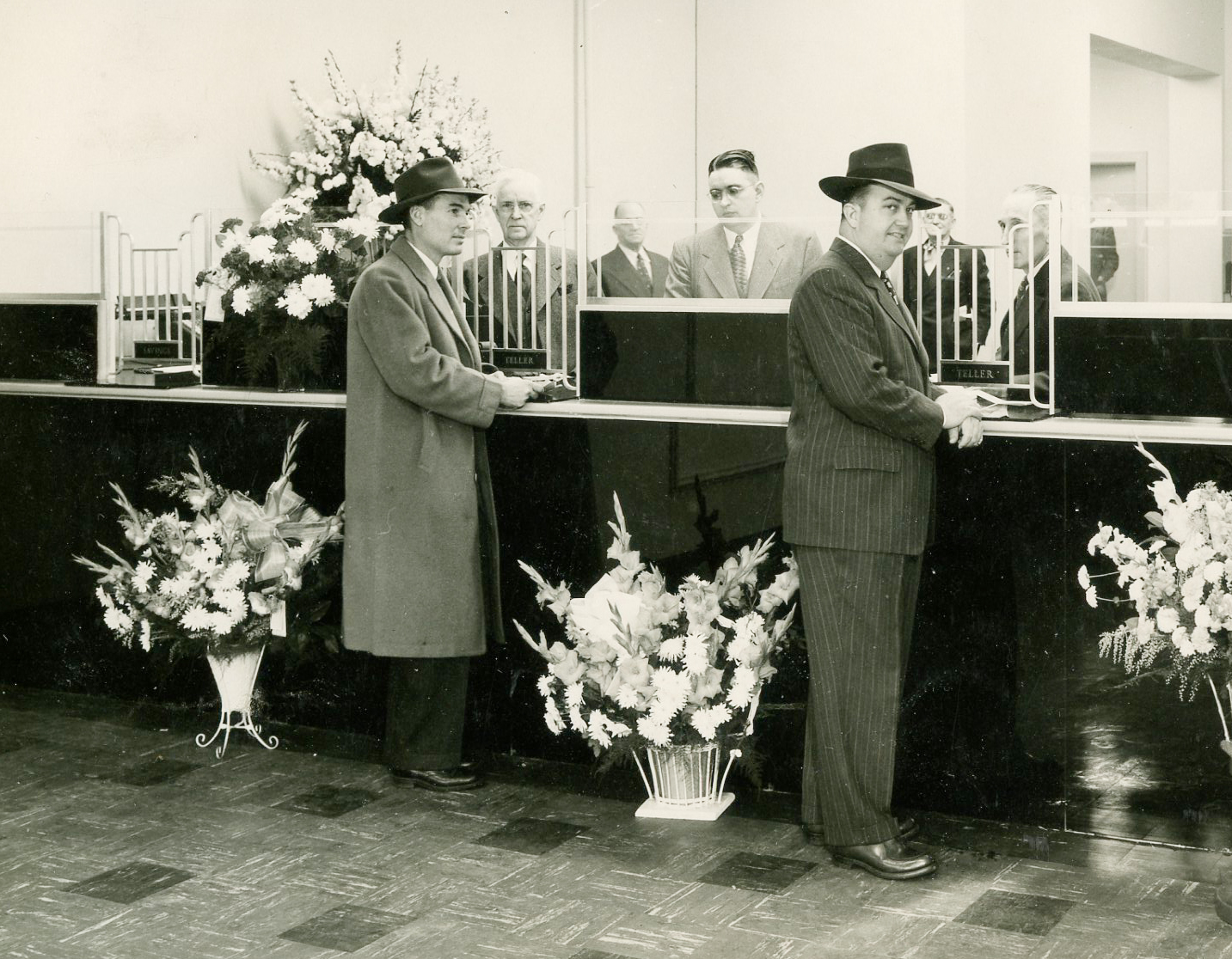 Paducah Opening Day: Two men at a counter with flowers