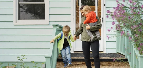 A family walking out of their new home.